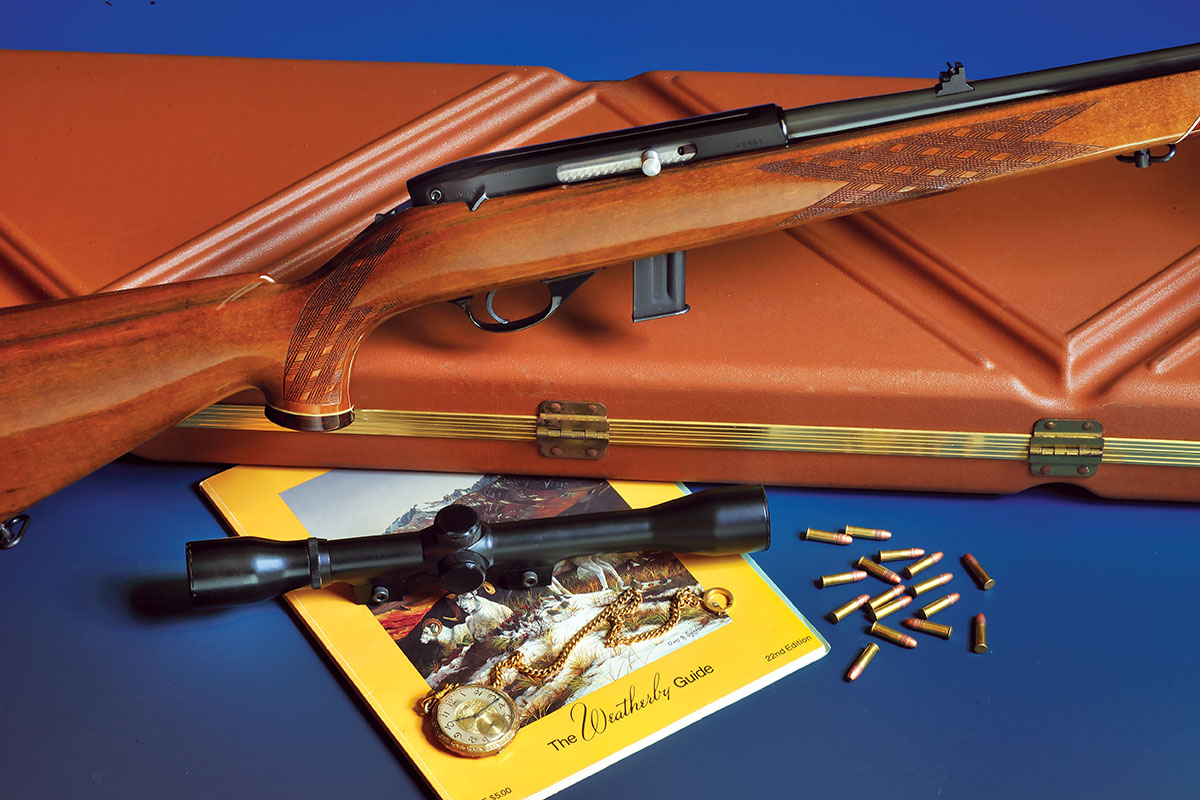 The Weatherby Mark XXII and the scope that started it all. A Weatherby case from the past and the company guide from 1985 are also shown.